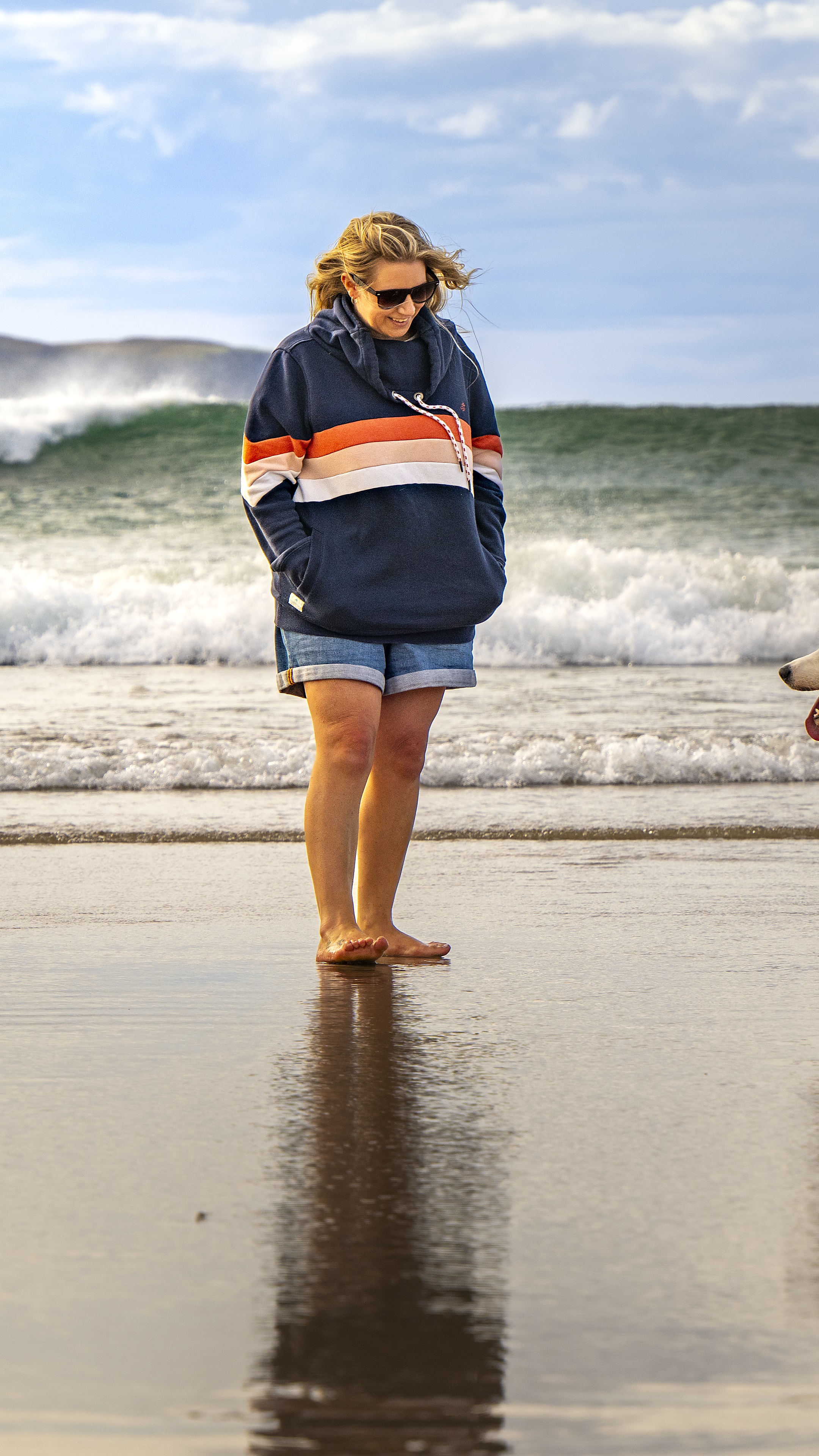 Becca walking with dogs on the beach at sunset